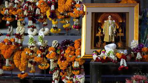 Et portrett av Thailands avdøde kong Bhumibol Adulyadej blant blomsterkranser på Siriraj-sykehuset i Bangkok, Thailand der han torsdag sovnet inn, 88 år gammel. Foto: Chaiwat Subprasom/