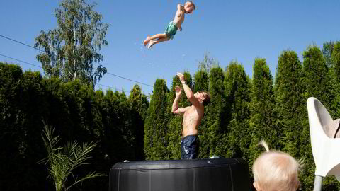 Espen Rongved øver på høydekast med sønnen Dexter i familiens boblebad, mens lillesøster ser på.