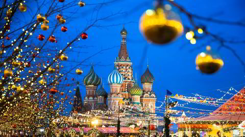 People walk in Red Square decorated for Christmas and New Year celebrations, with the St. Basil's Cathedral in the background in Moscow, Russia, Saturday, Dec. 21, 2019. (AP Photo/Pavel Golovkin)