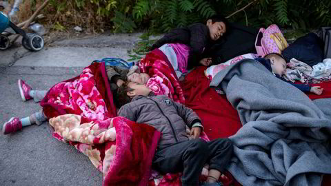 Children sleep on the road near the fire-destroyed Moria refugee and migrant camp on the island of Lesbos, Greece, Thursday, Sept. 10, 2020. A second fire in Greece's notoriously overcrowded Moria refugee camp destroyed nearly everything leaving thousands more people in need of emergency housing. (AP Photo/Petros Giannakouris) ---
