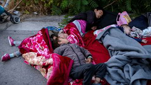 Children sleep on the road near the fire-destroyed Moria refugee and migrant camp on the island of Lesbos, Greece, Thursday, Sept. 10, 2020. A second fire in Greece's notoriously overcrowded Moria refugee camp destroyed nearly everything leaving thousands more people in need of emergency housing. (AP Photo/Petros Giannakouris) ---