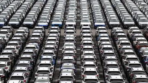 (FILES) New vehicles are parked at Daikoku Pier in Yokohama on April 2, 2025. Japanese Prime Minister Shigeru Ishiba on July 23 said US auto tariffs would be cut to 15 percent from 25 percent, after the two countries reached a trade deal. (Photo by Philip FONG / AFP)