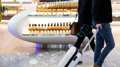 Reisende passerer taxfreebutikken i avgangshallen på Oslo Lufthavn Gardermoen.